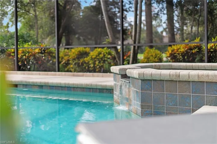 View of swimming pool with pool water feature