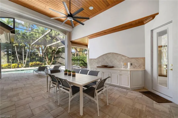 Sunroom / solarium with a pool, ceiling fan, and wooden ceiling