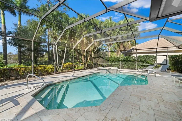 View of pool with a lanai, a patio area, and an in ground hot tub