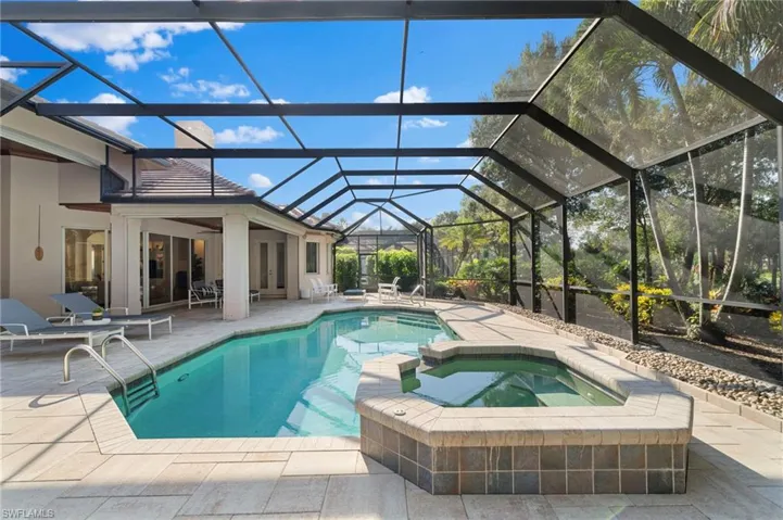 View of swimming pool with an in ground hot tub, a patio, ceiling fan, and a lanai