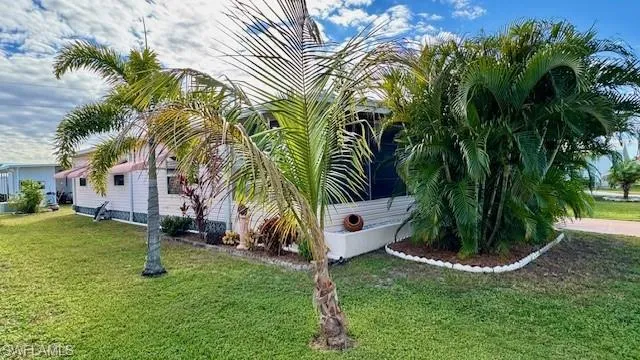 View of side of home with a yard