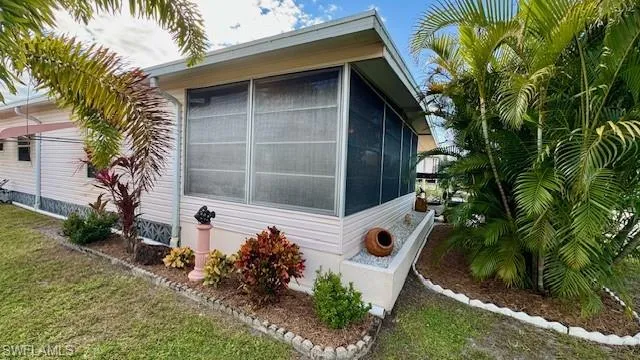 View of property exterior with a sunroom