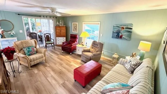 Large living room with ceiling fan and lots of natura lighting