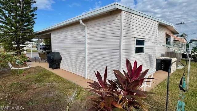 View of side of home with a lawn