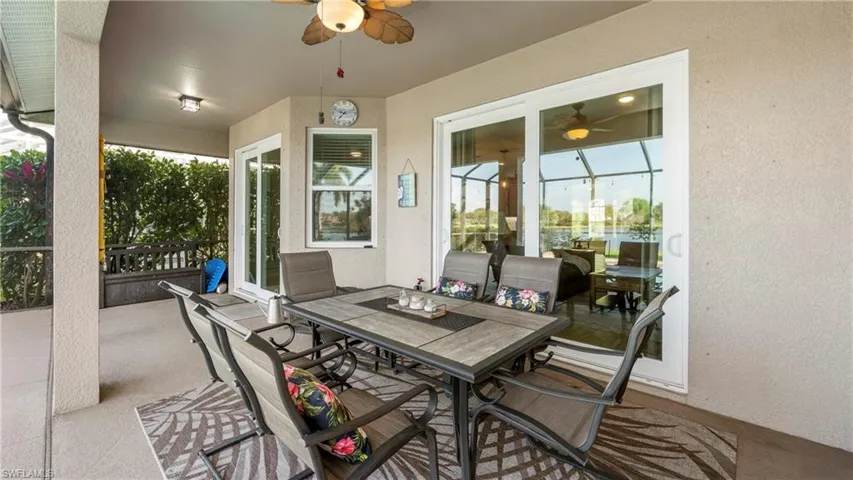 View of patio with outdoor dining space and ceiling fan