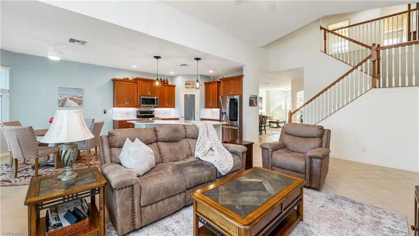 Living area with a ceiling fan and light tile patterned floors