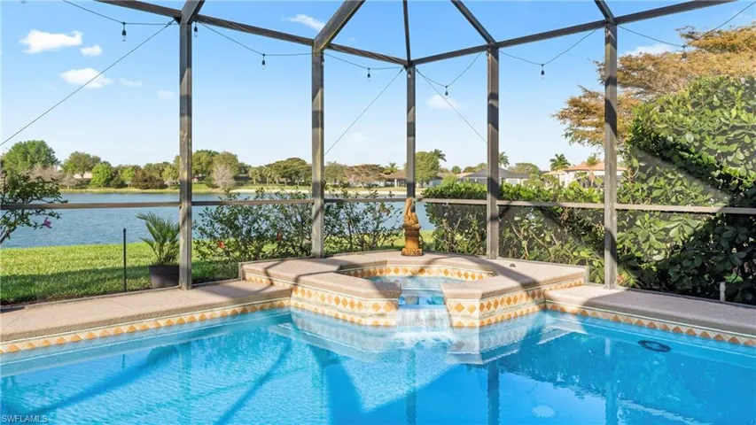 Integrated pool / spa featuring a lanai and a sunroom