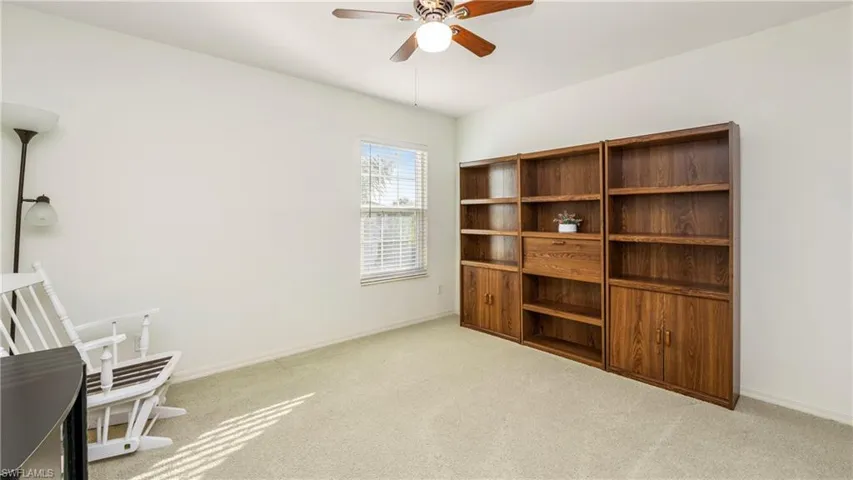 Bedroom with light carpet and a ceiling fan