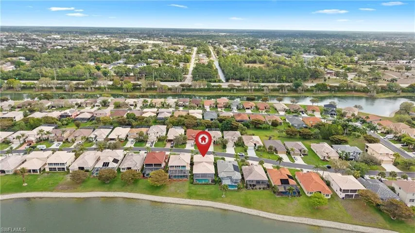 Aerial view of residential area featuring a large body of water