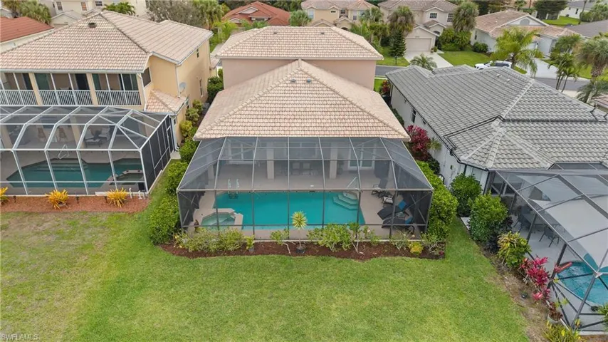 Aerial perspective of suburban area with a pool area