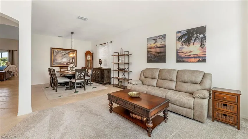 Living room featuring light tile patterned floors and healthy amount of natural light