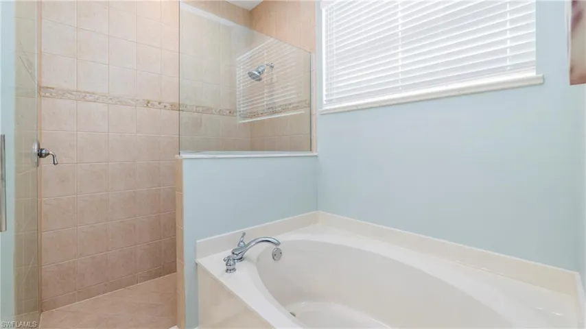 Master Bathroom with walk in shower and a garden tub