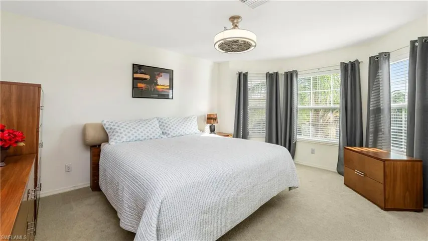 Bedroom featuring light colored carpet and baseboards