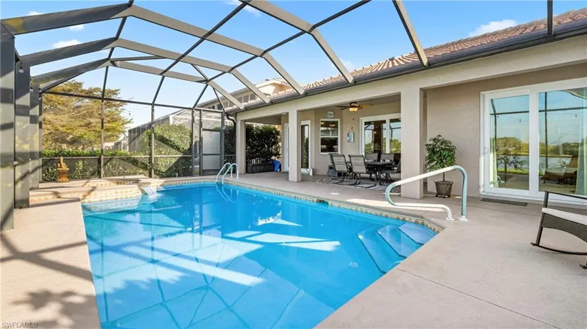 Outdoor pool featuring a patio, a sunroom, a lanai, and outdoor dining area