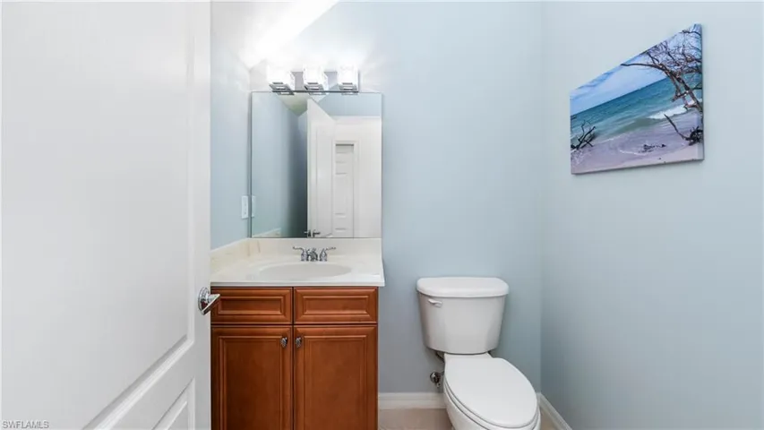 Half bathroom featuring vanity and toilet