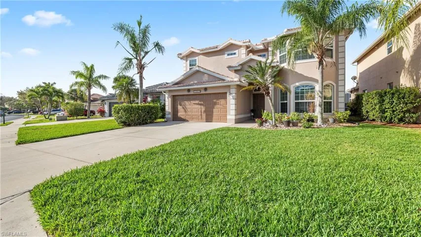 Mediterranean / spanish-style home with stucco siding, a front lawn, concrete driveway, a garage, and a tiled roof