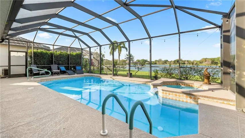 Combined pool / hot tub featuring a sunroom, a patio area, and glass enclosure