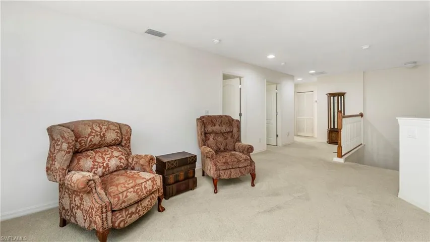 Loft featuring an upstairs landing, light carpet, and recessed lighting