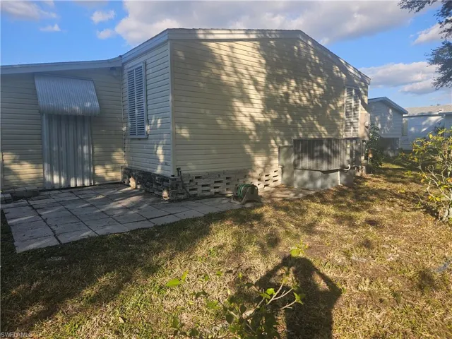 View of side of home featuring a patio area