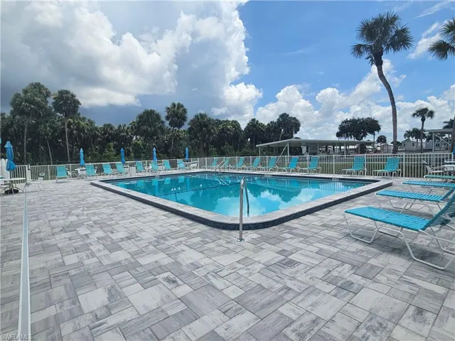 Community pool featuring a patio