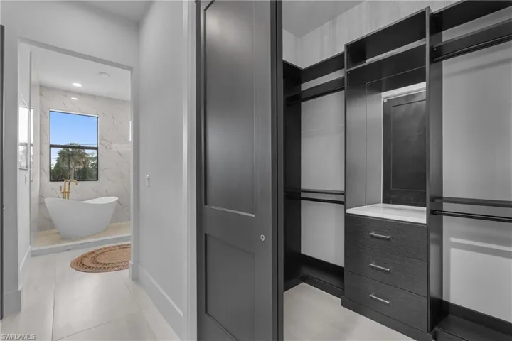 Spacious closet with light tile patterned flooring