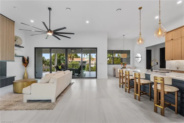 Living room with plenty of natural light, recessed lighting, and a ceiling fan