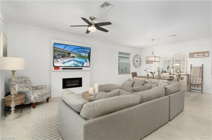 Custom designed sleek electric fire place is a focal point to the room adding character and style