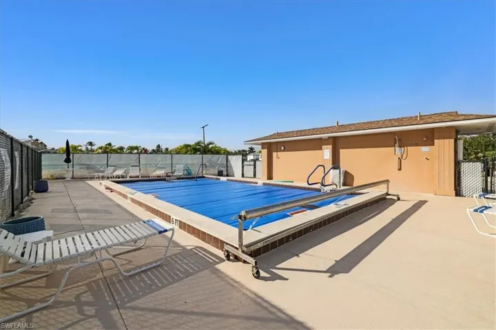 Community pool with a patio