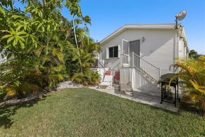 Rear view of property with a yard and a patio area