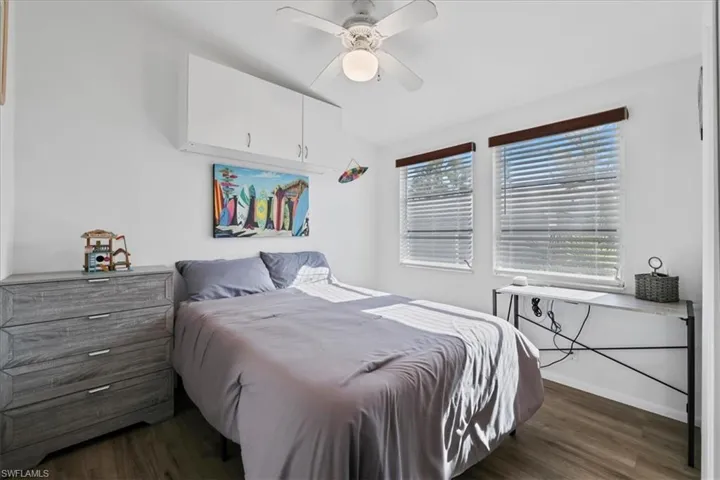 Bedroom featuring dark wood finished floors and a ceiling fan