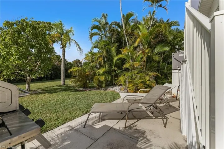 View of green lawn with a patio