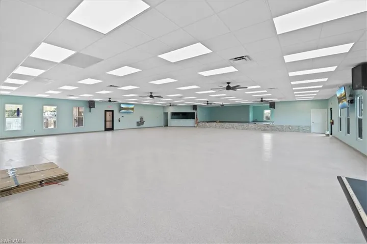 Miscellaneous room with a ceiling fan and a paneled ceiling
