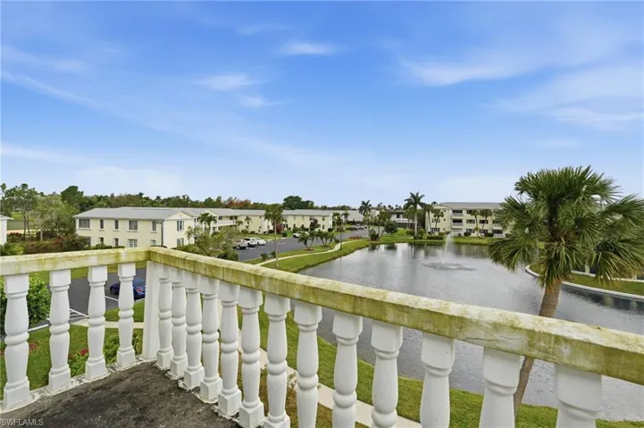 Balcony featuring a water view and a residential view