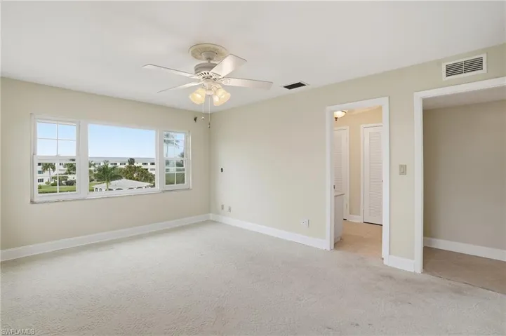Unfurnished bedroom featuring light colored carpet and a ceiling fan