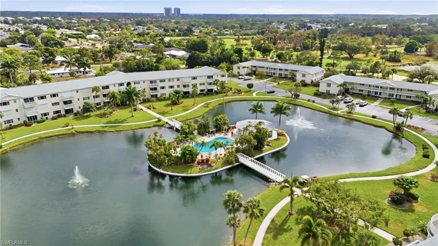 Bird's eye view of a nearby body of water and apartment complex / building