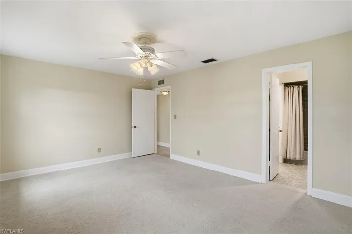 Spare room with light carpet and ceiling fan