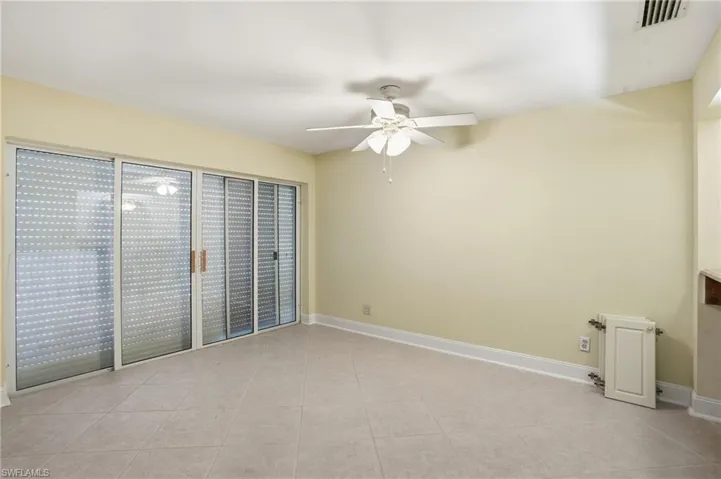 Spare room with ceiling fan and light tile patterned floors