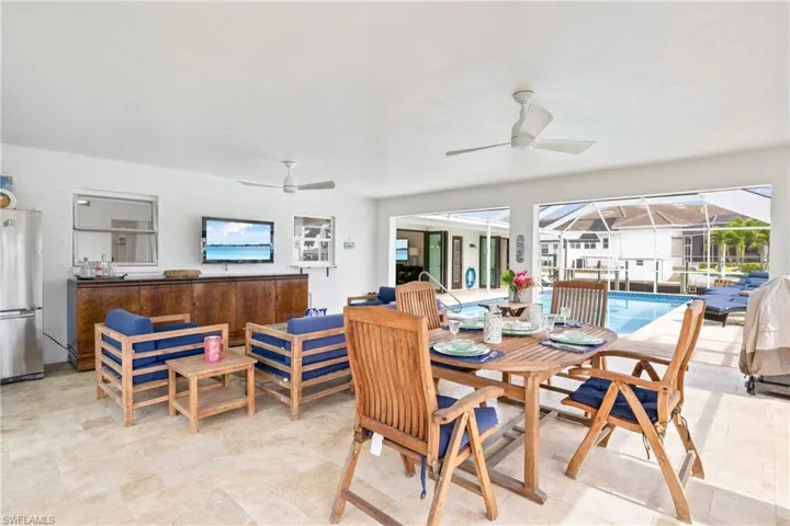 Dining room featuring a sunroom and ceiling fan