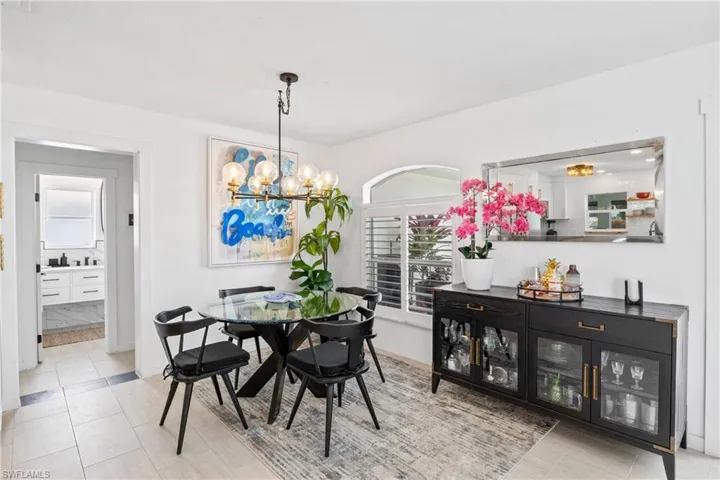 Dining room with a chandelier and light tile patterned flooring
