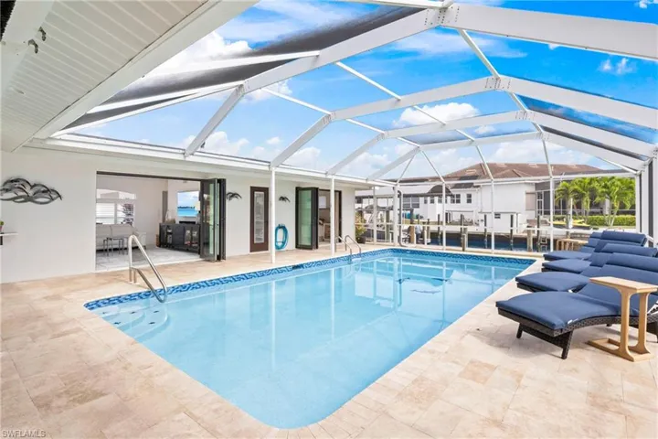 View of pool with a swimming pool, a lanai, and patio surround