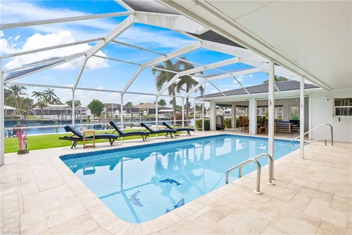 Outdoor pool with a lanai, a patio, and a sunroom