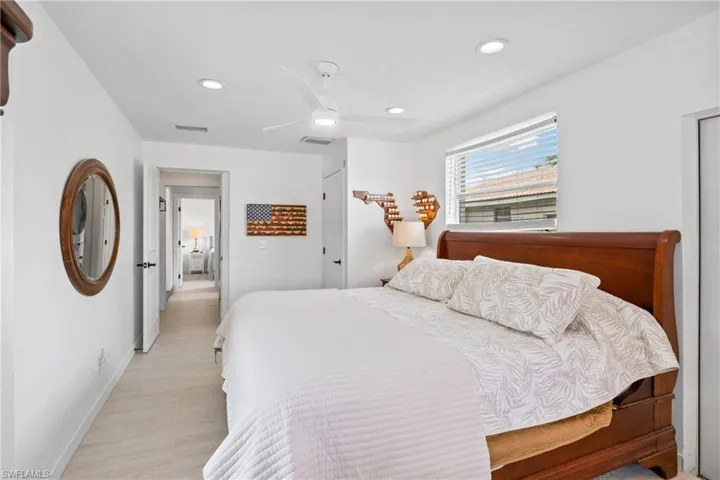 Bedroom with ceiling fan, recessed lighting, light wood-style flooring, and a closet