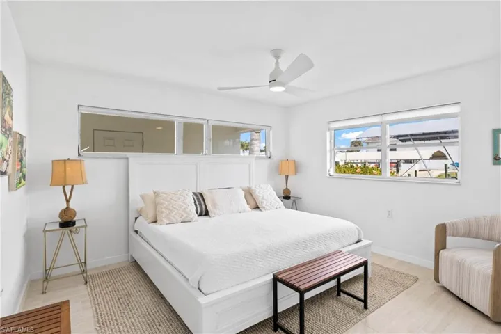 Bedroom with ceiling fan and baseboards