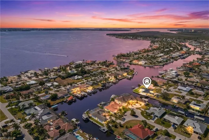 Aerial view of residential area featuring a large body of water