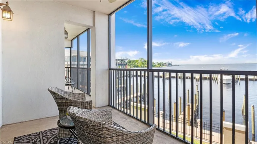 Balcony with a water view and a sunroom