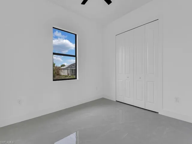 Unfurnished bedroom with a closet and ceiling fan