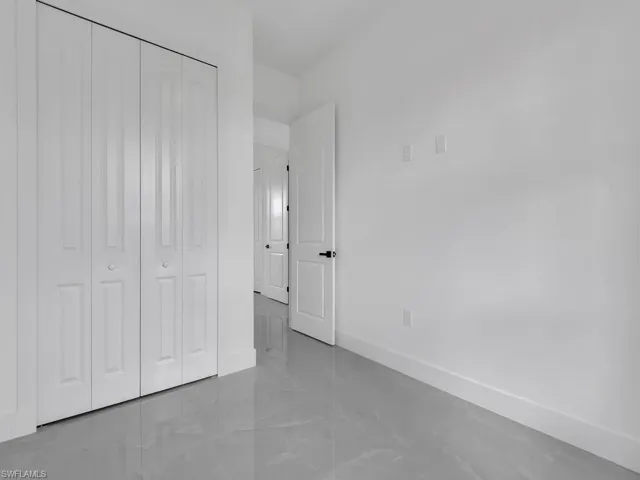 Unfurnished bedroom featuring baseboards and a closet