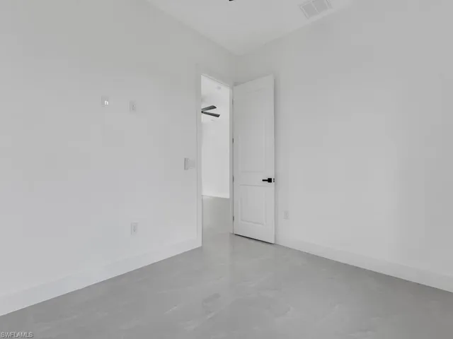 Unfurnished room featuring baseboards