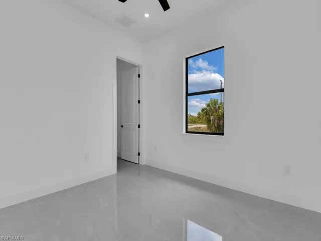 Spare room with finished concrete flooring, ceiling fan, and recessed lighting
