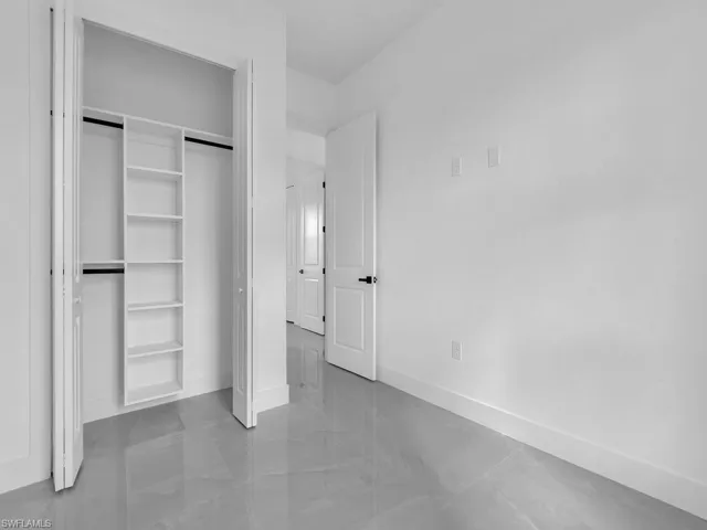 Unfurnished bedroom featuring a closet and baseboards
